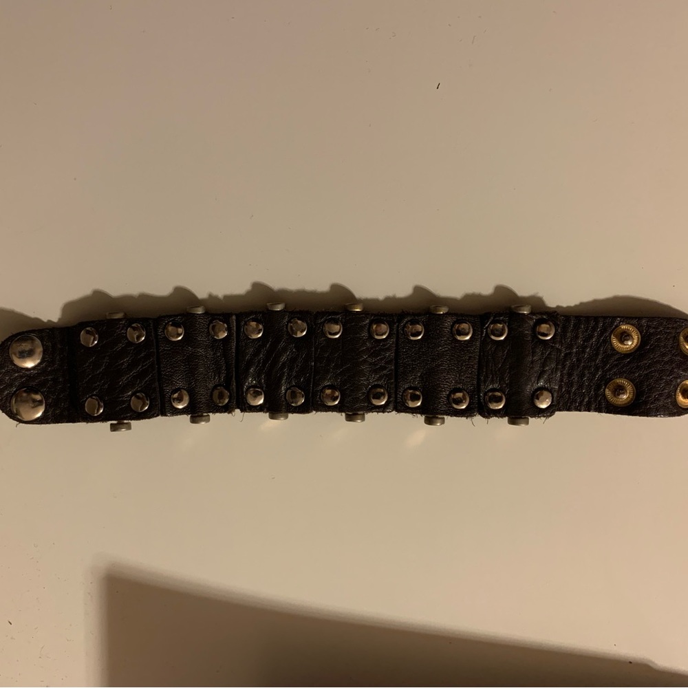 Brown leather snap on cuff with gold studs. Fits large wrist.